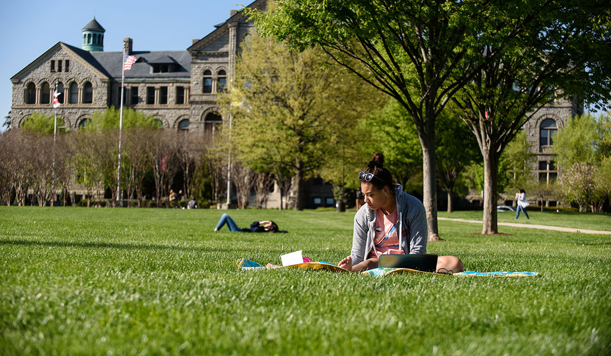 Student sitting on grass