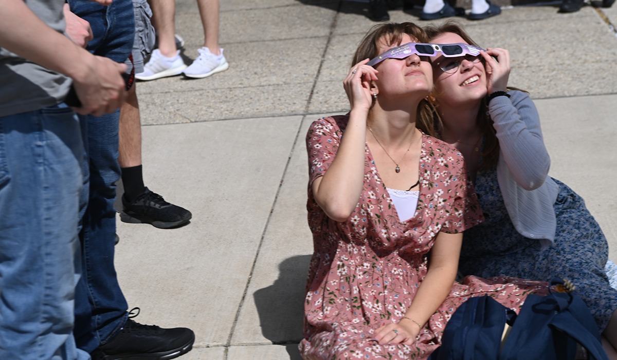 Students share the eclipse experience and protective glasses outside Hannan Hall (Catholic University/Patrick G. Ryan)
